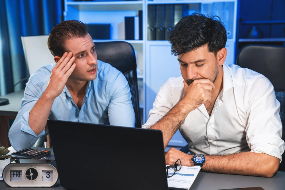 two men analyzing paperwork project together