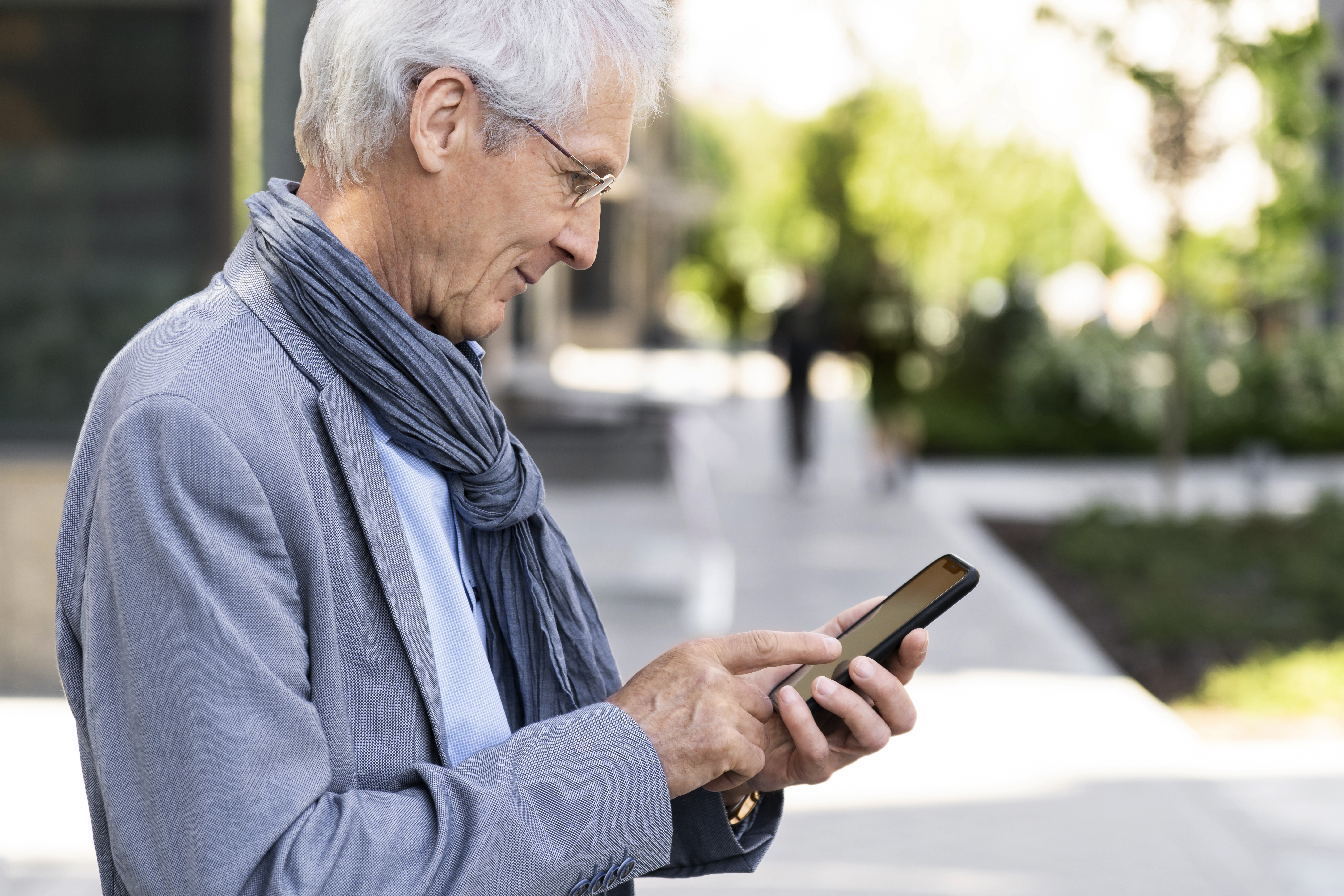 an elder man using mobile phone