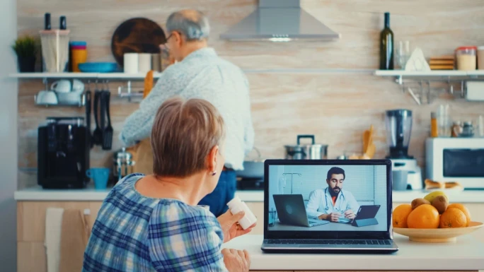 Senior woman joins video conference with doctor